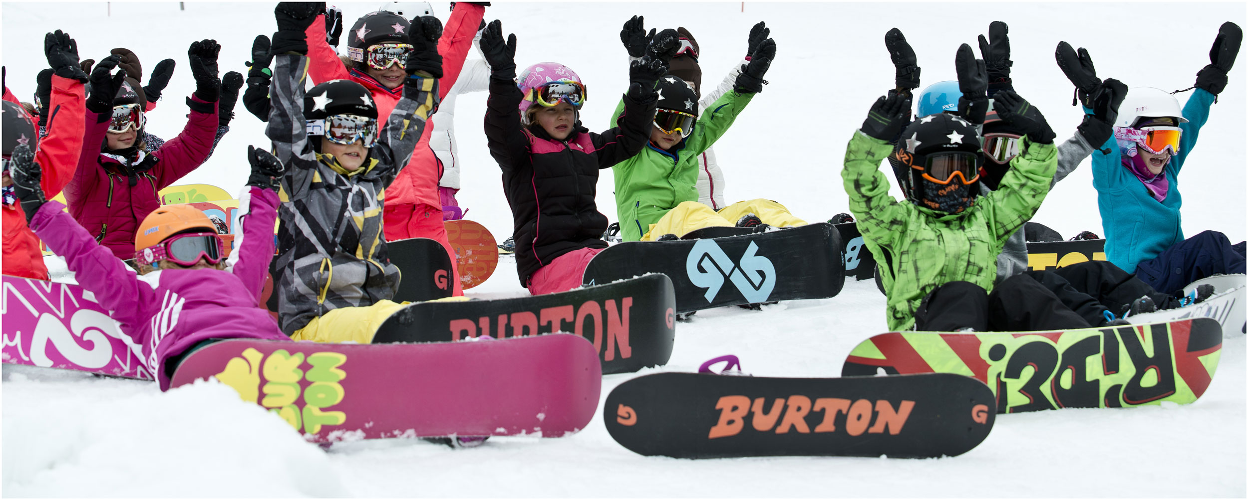 Kids learning to snowboard