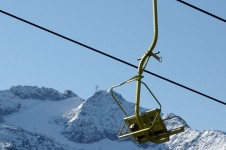 Use a chairlift for the first time as you learn to ski in Andermatt